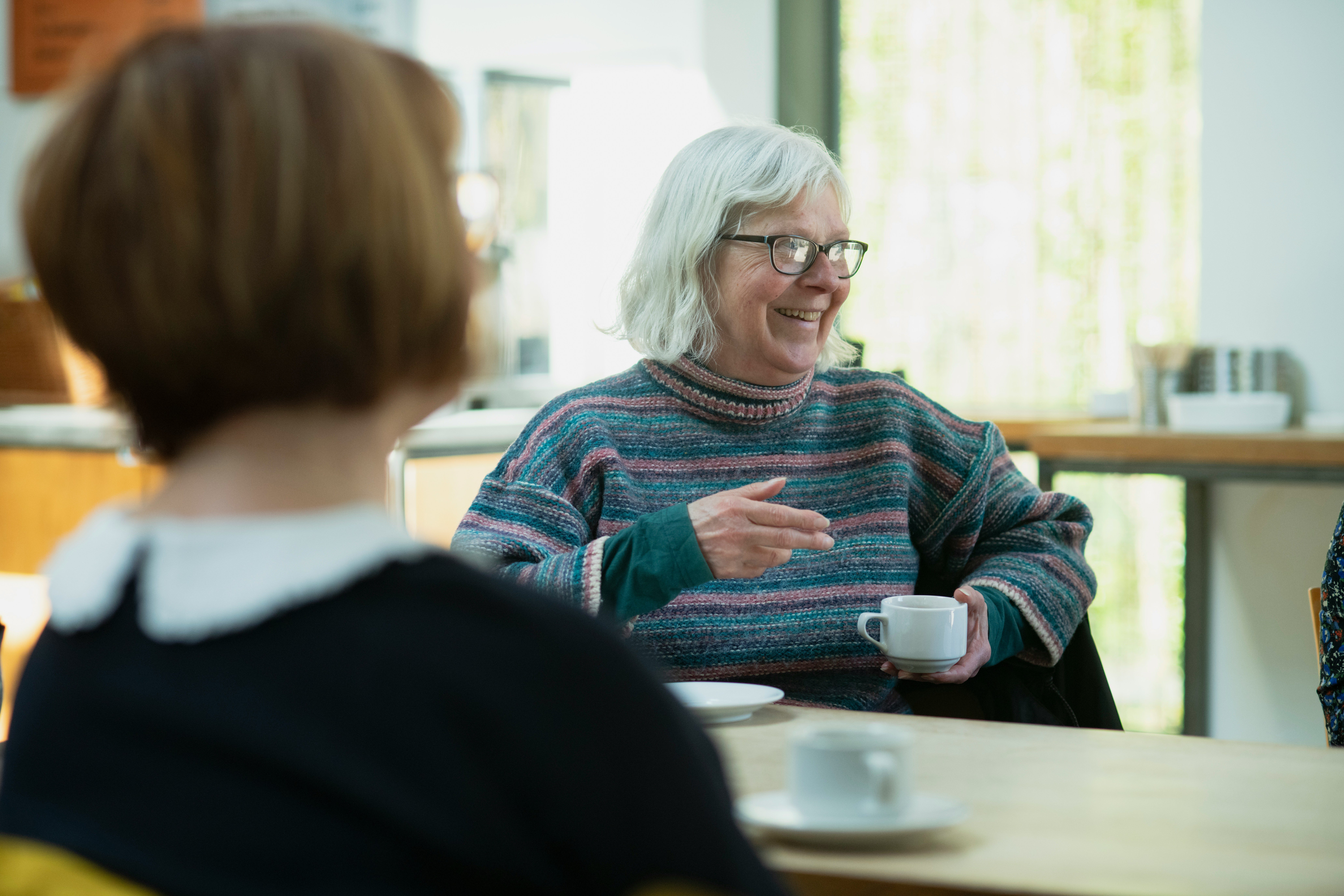 Woman smiling with coffee cup